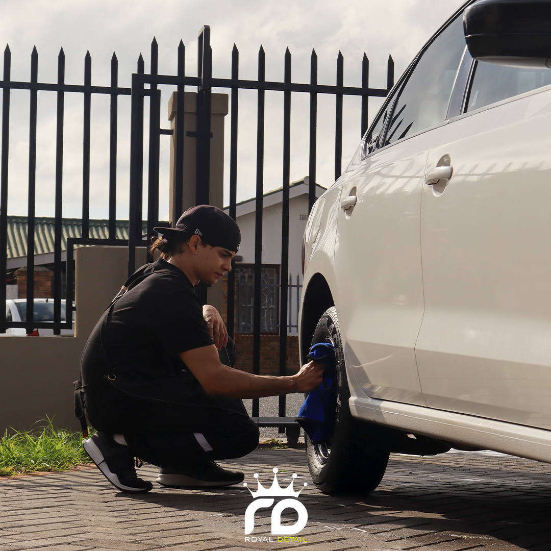 Wheel detailing service on a white sedan